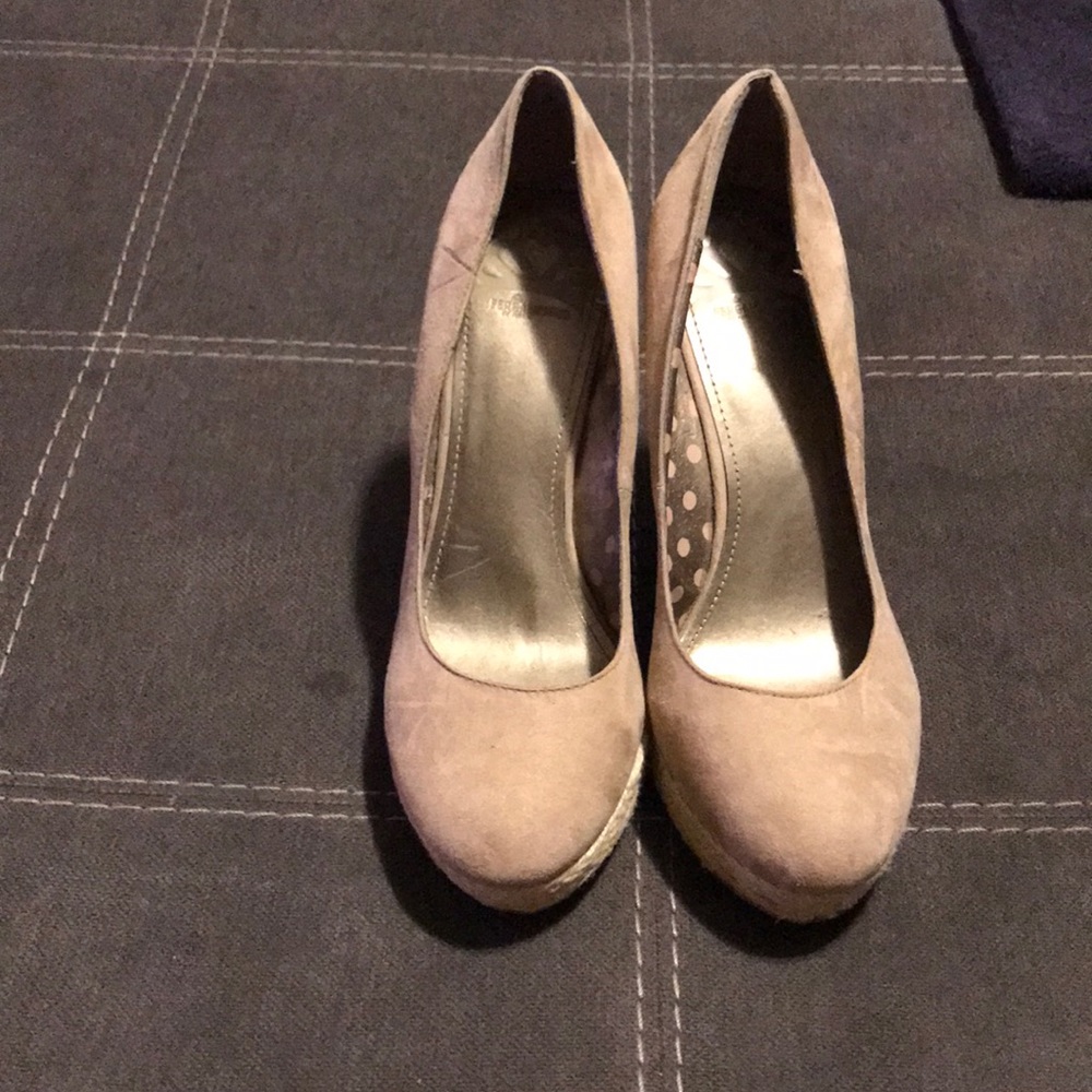 Beige heels with woven wedges.